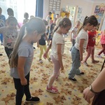 Grupa dzieci tańczy na dywanie.jpg