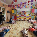 Dzieci leżą na dywanie i słuchają muzyki.jpg